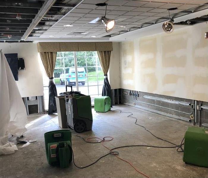 drying equipment setup during water damage restoration in conference room