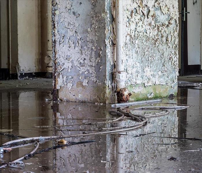 Flooded commercial building with bad structural damages including chipped paint